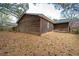 Back exterior of the home with wood paneling and a view of the backyard at 6347 Steepleridge Ct, Riverdale, GA 30296