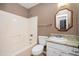 Standard bathroom with tub and shower, toilet, and sink with cabinet at 6347 Steepleridge Ct, Riverdale, GA 30296