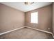 This bedroom features neutral paint, a light-colored carpet and bright light from the window at 6347 Steepleridge Ct, Riverdale, GA 30296