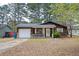 Cozy single-story home with a white garage door, front porch, and lawn at 6347 Steepleridge Ct, Riverdale, GA 30296