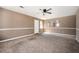 Spacious living room with carpet, ceiling fan, and natural light at 6347 Steepleridge Ct, Riverdale, GA 30296