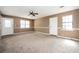 Large living room featuring carpet, a ceiling fan, with natural light at 6347 Steepleridge Ct, Riverdale, GA 30296