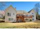 Spacious backyard featuring a wooden deck accessible by stairs from the back of the house at 8005 Sweet Creek Rd, Johns Creek, GA 30097