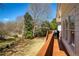 Backyard deck with a beautiful green lawn, trees, and stone drain at 8005 Sweet Creek Rd, Johns Creek, GA 30097