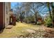 View of a lawn from a porch, showing the drain stones and mature trees at 8005 Sweet Creek Rd, Johns Creek, GA 30097