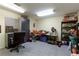 Functional basement area with storage shelves, workspace, and a rolling office chair at 8005 Sweet Creek Rd, Johns Creek, GA 30097