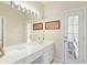 Bathroom featuring a large mirror, ample counter space, and access to an outdoor area, combining convenience and relaxation at 8005 Sweet Creek Rd, Johns Creek, GA 30097