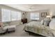 Serene bedroom with natural light, a ceiling fan, soft bedding, and a classic dresser at 8005 Sweet Creek Rd, Johns Creek, GA 30097