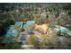 A high angle, full shot, aerial view of a community with tennis courts, a pool, and a playground at 8005 Sweet Creek Rd, Johns Creek, GA 30097