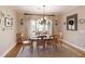 Well-lit dining room with a neutral color palette, stylish chandelier, and decorative accents at 8005 Sweet Creek Rd, Johns Creek, GA 30097