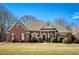 Beautiful brick home with a well-manicured lawn and lovely landscaping at 8005 Sweet Creek Rd, Johns Creek, GA 30097