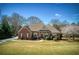 Beautiful single-story brick home with a well-manicured lawn, mature landscaping, and inviting front entrance at 8005 Sweet Creek Rd, Johns Creek, GA 30097