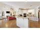 Bright open-concept kitchen with bar seating, white cabinets, and hardwood floors at 8005 Sweet Creek Rd, Johns Creek, GA 30097