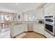 Kitchen featuring stainless steel appliances, a breakfast bar, and an adjacent dining area at 8005 Sweet Creek Rd, Johns Creek, GA 30097