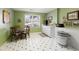 Bright kitchen area showcasing green walls, a cozy breakfast nook, and practical amenities at 8005 Sweet Creek Rd, Johns Creek, GA 30097