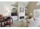 Cozy living room with a fireplace, built-in shelving, and lots of natural light at 8005 Sweet Creek Rd, Johns Creek, GA 30097