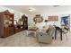 Comfortable living room featuring tile floors, bookshelves and a large sofa, ideal for relaxation at 8005 Sweet Creek Rd, Johns Creek, GA 30097