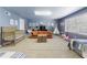 Playful living room with comfy seating, a crib, and room for various activities at 8005 Sweet Creek Rd, Johns Creek, GA 30097