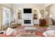 Comfortable living area featuring a fireplace, built-in shelving, and lots of natural light at 8005 Sweet Creek Rd, Johns Creek, GA 30097