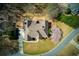 A bird's eye view of a house, highlighting the roof, landscaping, and surrounding green space at 8005 Sweet Creek Rd, Johns Creek, GA 30097
