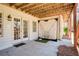 Covered patio area with french doors and a golf net at 8005 Sweet Creek Rd, Johns Creek, GA 30097
