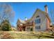 Rear view of a home with a deck and stair access, showcasing the architecture and outdoor space at 8005 Sweet Creek Rd, Johns Creek, GA 30097