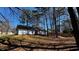 Expansive backyard with mature trees and a sloped landscape at 309 Peachtree Dr, Riverdale, GA 30274