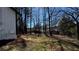 View of a home's partially fenced backyard with bare trees and some lawn at 309 Peachtree Dr, Riverdale, GA 30274