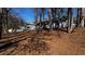 View of a home's partially fenced backyard with bare trees and some lawn at 309 Peachtree Dr, Riverdale, GA 30274