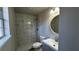 Modern bathroom featuring a tiled walk-in shower, hexagon tile floor, and contemporary fixtures at 309 Peachtree Dr, Riverdale, GA 30274