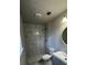 Modern bathroom featuring a tiled walk-in shower, hexagon tile floor, and contemporary fixtures at 309 Peachtree Dr, Riverdale, GA 30274