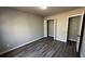 Neutral bedroom features wood-look flooring and closet space at 309 Peachtree Dr, Riverdale, GA 30274