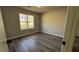 A bedroom featuring wood-look flooring and a window offering plenty of natural light at 309 Peachtree Dr, Riverdale, GA 30274