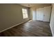 Well-lit bedroom features new laminate flooring, neutral walls, and closet for storage at 309 Peachtree Dr, Riverdale, GA 30274