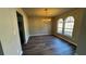 Dining room with wood-look floors and traditional chandelier lighting fixture at 309 Peachtree Dr, Riverdale, GA 30274