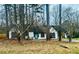 Charming one-story home with blue door and mature trees creating a private yard at 309 Peachtree Dr, Riverdale, GA 30274