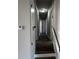 Hallway with wood-look floors and white doors leading to other areas of the house at 309 Peachtree Dr, Riverdale, GA 30274