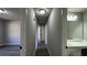 Hallway with laminate flooring and neutral paint leading to the other rooms in the home at 309 Peachtree Dr, Riverdale, GA 30274