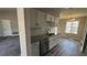 Kitchen featuring updated cabinets and stainless steel dishwasher, open to dining room at 309 Peachtree Dr, Riverdale, GA 30274