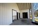 Covered back patio with three storage doors at 309 Peachtree Dr, Riverdale, GA 30274
