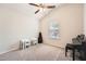 Neutral bedroom featuring a ceiling fan, window, and musical instruments, perfect for relaxation and hobbies at 636 Georgia Way, Woodstock, GA 30188