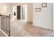 Upstairs hallway with neutral walls and carpet, featuring a wooden handrail and open doorways at 636 Georgia Way, Woodstock, GA 30188
