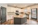 Modern kitchen featuring white cabinets, granite countertops, and stainless steel appliances at 636 Georgia Way, Woodstock, GA 30188