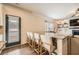 Open kitchen featuring granite counters, a breakfast bar with seating, and easy access to the outdoor patio at 636 Georgia Way, Woodstock, GA 30188
