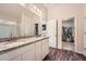 The main bathroom is equipped with a double sink vanity with granite counters and a walk-in closet at 636 Georgia Way, Woodstock, GA 30188