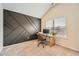 Bright office space with a modern accent wall, large windows, and neutral carpet at 636 Georgia Way, Woodstock, GA 30188