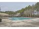Community pool with ample deck space and mature trees, perfect for summer relaxation and recreation at 636 Georgia Way, Woodstock, GA 30188