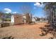 View of backyard with a wooden fence, mature trees, and lawn at 924 Evian Nw Dr, Kennesaw, GA 30152