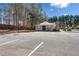 Community recreation area with a basketball court, parking, and pool house by tall mature trees at 924 Evian Nw Dr, Kennesaw, GA 30152