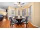 Bright breakfast nook featuring wood table, upholstered chairs, hardwood floors and an adjacent outdoor patio at 924 Evian Nw Dr, Kennesaw, GA 30152